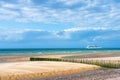 pretty landscape of the coast in northern France with a ferry going along the beach