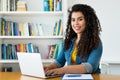 Pretty latin american woman in quarantine at computer