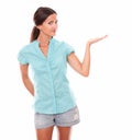 Pretty latin girl in blue shirt holding palm up Royalty Free Stock Photo