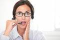 Pretty latin secretary conversing on headphones Royalty Free Stock Photo