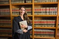 Pretty lawyer looking at camera in the law library Royalty Free Stock Photo