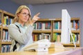 Pretty librarian working in the library Royalty Free Stock Photo