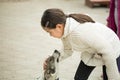 Pretty little asian girl palying with dog
