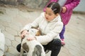 Pretty little asian girl palying with dog