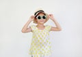 Pretty little asian kid girl wearing a sunglasses and straw hat isolated on white background. Summer and fashion concept. Front Royalty Free Stock Photo