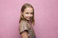 Pretty little child girl with cute smile posing over pink studio wall banner background, fashion portrait Royalty Free Stock Photo