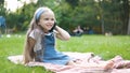 Pretty little child girl having conversation on her mobile phone in summer park Royalty Free Stock Photo