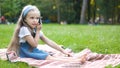 Pretty little child girl having conversation on her mobile phone in summer park Royalty Free Stock Photo