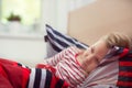 Pretty little child girl laying in bed and drink tea Royalty Free Stock Photo