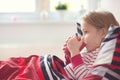 Pretty little child girl laying in bed and drink tea Royalty Free Stock Photo