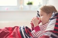 Pretty little child girl laying in bed and drink tea