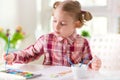 Pretty little child girl painting with colorful paint at home Royalty Free Stock Photo