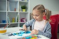 Pretty little child girl painting with colorful paint at home Royalty Free Stock Photo