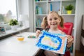 Pretty little child girl painting with colorful paint at home Royalty Free Stock Photo