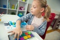 Pretty little child girl painting with colorful paint at home Royalty Free Stock Photo