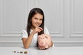 Little child girl with piggy bank at home Royalty Free Stock Photo