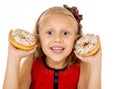 Pretty little female child holding two sugar donuts smiling happy