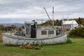 Pretty little fishing boat washed up in a field