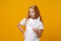 Pretty little ginger kid girl 12-13 years old in white t-shirt isolated on bright yellow wall background children studio Royalty Free Stock Photo