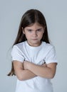 Pretty little girl with a angry facial expression looking mad at the camera. Children emotions Royalty Free Stock Photo