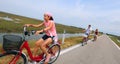 Pretty little girl with bandana on the bike and his family with Royalty Free Stock Photo