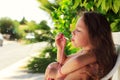 Pretty little girl blowing soap bubbles outdoor at sunset - happy carefree childhood