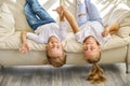 Pretty little girl and boy are lying on sofa in living room Royalty Free Stock Photo