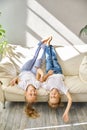 Pretty little girl and boy are lying on sofa in living room Royalty Free Stock Photo