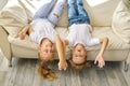 Pretty little girl and boy are lying on sofa in living room Royalty Free Stock Photo