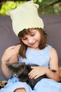 Pretty little girl caress the domestic animal