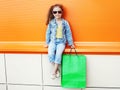 Pretty little girl child wearing a jeans clothes with shopping bags Royalty Free Stock Photo