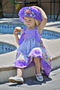 Pretty little girl in colorful dress and hat