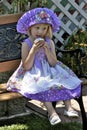 Pretty little girl in colorful dress and hat