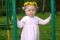 Pretty little girl with dandelion flower garland. Royalty Free Stock Photo