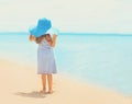 Pretty little girl in dress and straw hat enjoying sea Royalty Free Stock Photo