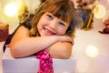 pretty little girl in a dress waiting at the foot of the Christmas tree for the opening of presents Royalty Free Stock Photo