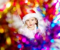 Pretty little girl dressed in santa red hat, new year portrait w Royalty Free Stock Photo