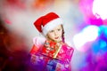 Pretty little girl dressed in santa red hat, new year portrait w Royalty Free Stock Photo