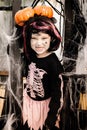 Pretty little girl dressing up as a witch in a Halloween setting Royalty Free Stock Photo