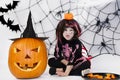 Pretty little girl dressing up as a witch in a Halloween setting Royalty Free Stock Photo