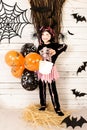 Pretty little girl dressing up as a witch in a Halloween setting Royalty Free Stock Photo