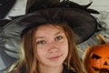 Pretty little girl dressing up as a witch in a Halloween setting Royalty Free Stock Photo