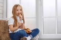 Pretty little girl eats cookies with chocolate milk. Royalty Free Stock Photo