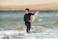 pretty little girl enjoying surfing the waves with a bodyboard during her vacation Royalty Free Stock Photo