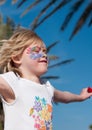 Pretty little girl with facepainting on her face feels exited, and jumping in the air Royalty Free Stock Photo