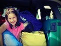 Pretty little girl fills the suitcases on the car with vintage Royalty Free Stock Photo