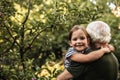 Pretty little girl with her grandfather in garden Royalty Free Stock Photo