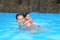 Pretty little girl with her mother playing in swimming pool outdoors Royalty Free Stock Photo