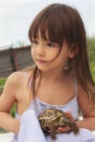 Pretty little girl holding a russian tortoise