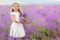 Pretty little girl in lavender field with basket